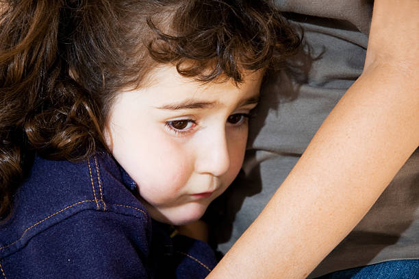 Spaventata/ragazza triste con braccia della madre - foto stock