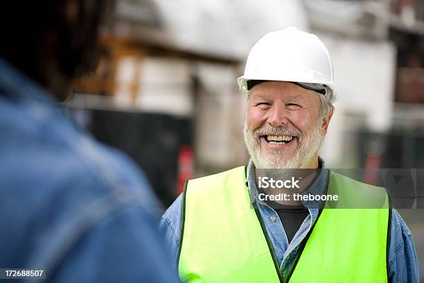 Photo Of Smiling Bearded Construction Worker In Green Vest Stock Photo - Download Image Now
