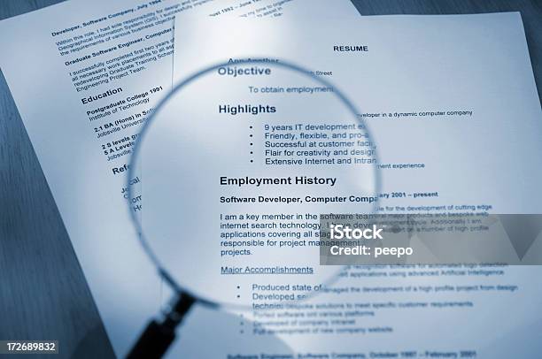 Magnifying Glass Examining Resume Stock Photo - Download Image Now - Résumé, Writing - Activity, Analyzing