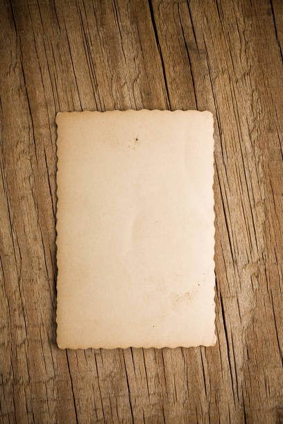 istock Old paper over wood 172690012