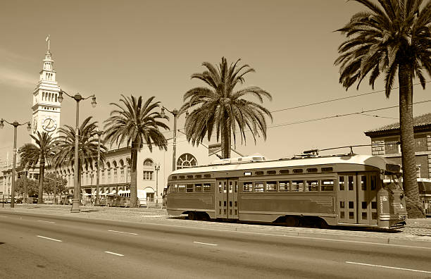 Classic San Francisco Retro style photo of the Ferry Building and Trolley at the Embarcadero in San Francisco, California.  fishermans wharf san francisco photos stock pictures, royalty-free photos & images