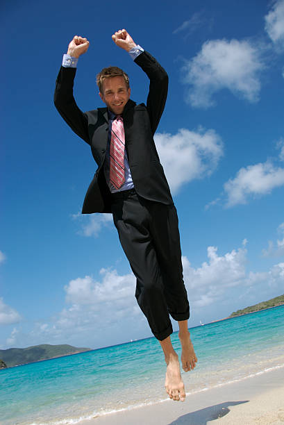 istock Businessman Flies Like a Superhero on Tropical Beach 172690825