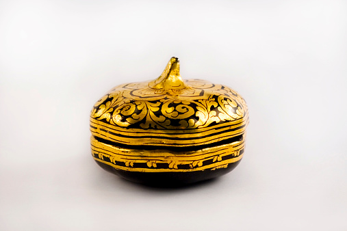 A wooden gold leaf handpainted antique box from Burma. It is a unique item.