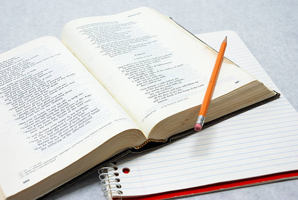 Open Bible with Notebook and Pencil stock photo