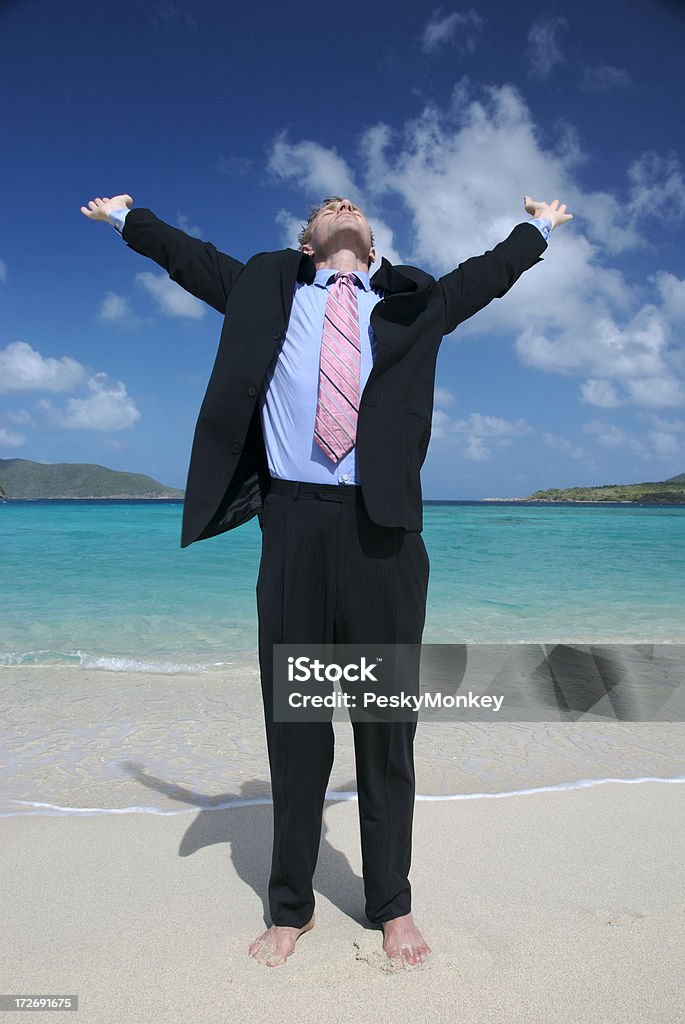 Uomo d'affari giovane uomo Stretching su una spiaggia tropicale in tuta - Foto stock royalty-free di 25-29 anni