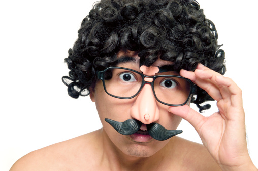 A man in disguise with wig and comedy eyeglasses on white background.  See more of wacky characters: