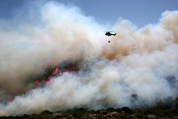 istock Fire helicopter extinguishes a fire with a fire bucket 172692224