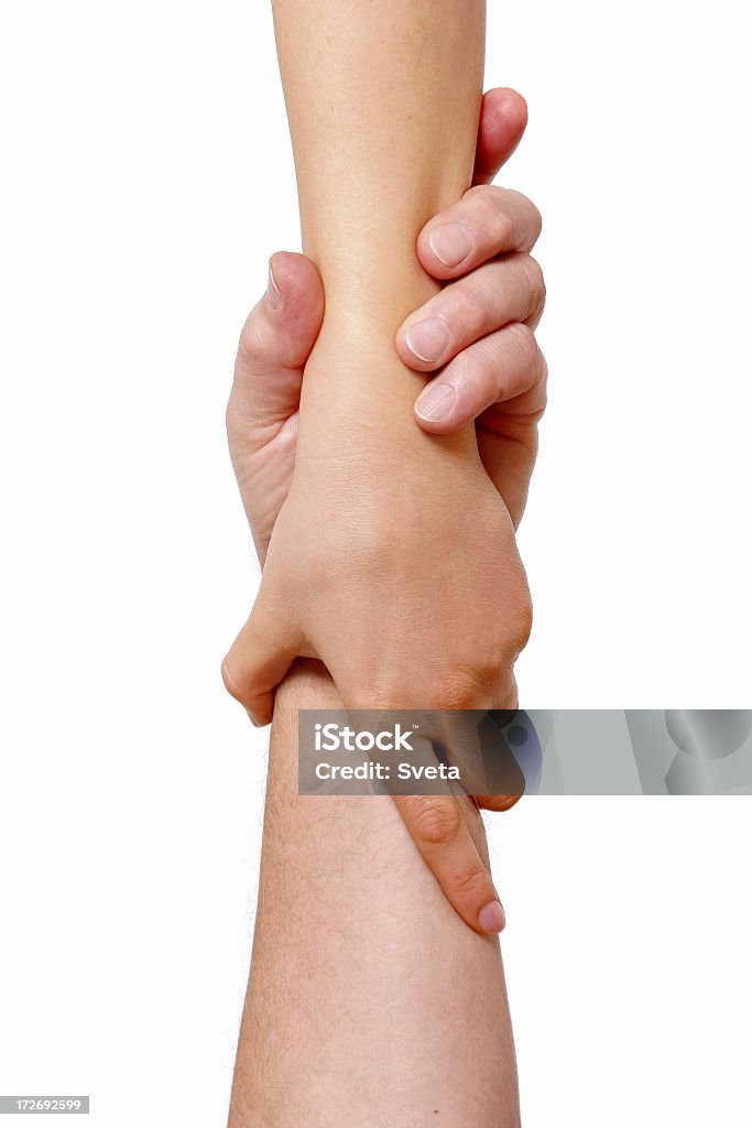 Two hands, each clasping the other forearm in a grasp A female's hand holding tight a male's hand Assistance Stock Photo