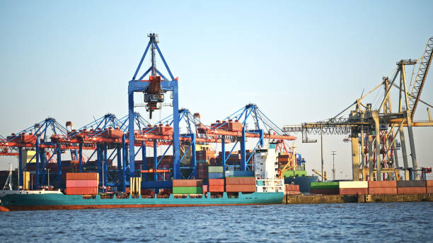 istock Cargo crane in sea port with containers 1726926848