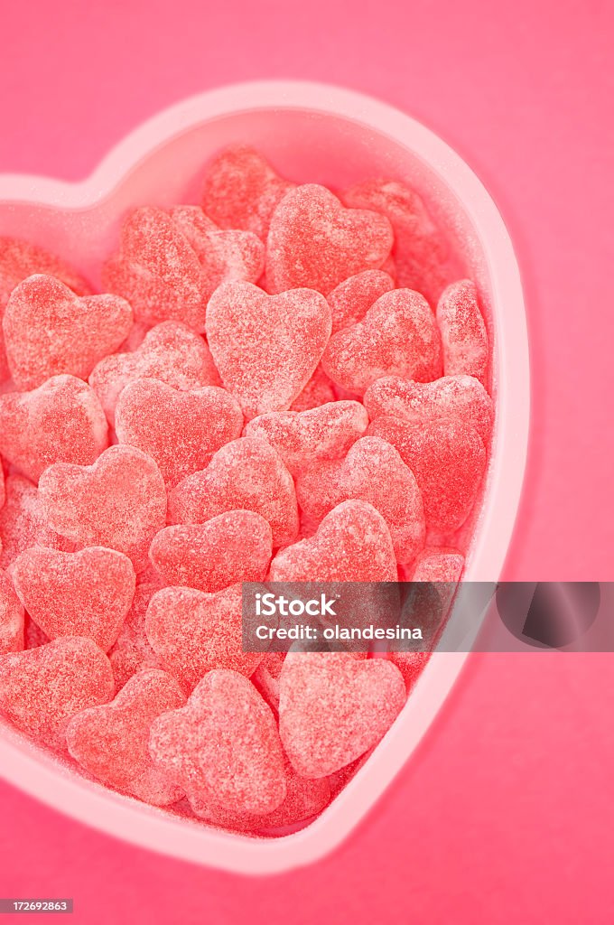 Heart full of love Heart full of sweet candies on plain background.  Accessibility Stock Photo