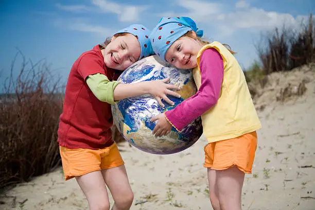 Photo of Little girls holding mother earth