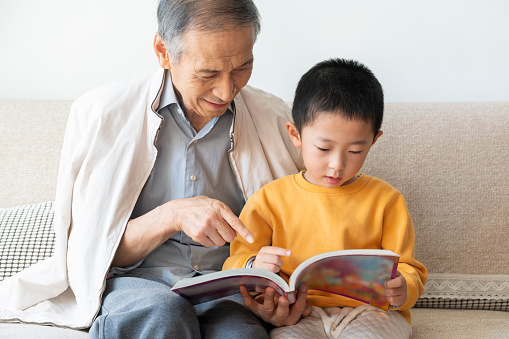 Grandpa and grandson read together