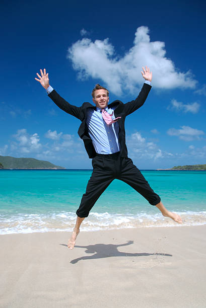 istock Smiling Businessman Does Spreadeagle Jump on Tropical Beach 172693673