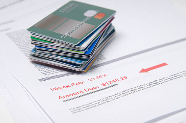 Stack of credit cards on account of value in red a stack of made up credit cards with a bill showing amount due consumer confidence photos stock pictures, royalty-free photos & images