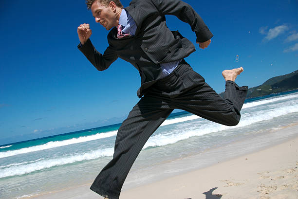 istock Businessman in Suit Leaps Across Tropical Scene 172693944