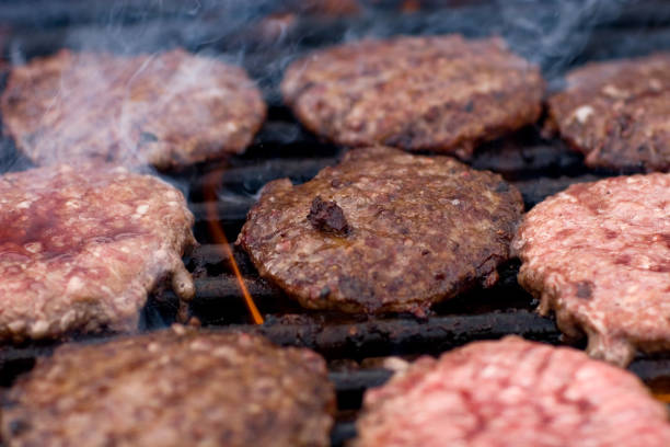 istock Hamburger patties cooking on a barbecue grill 172694223