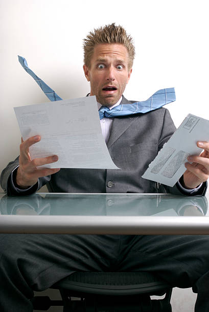 istock Shocked Businessman Office Worker Opening a Big Bad Bill 172694255