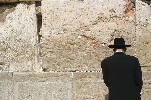 Western Wall Prayer A man prays at the Wailing Wall in Jerusalem wailing wall stock pictures, royalty-free photos & images