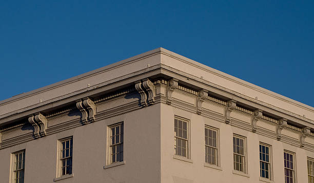 istock Brick building painted white against blue sky 172694998