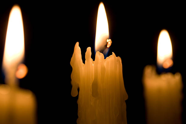 Three Candles on black stock photo