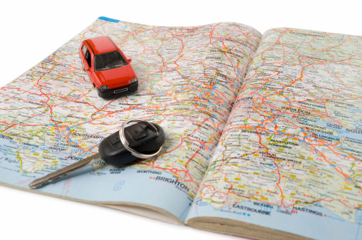 Road map with car key and toy car. Related images: