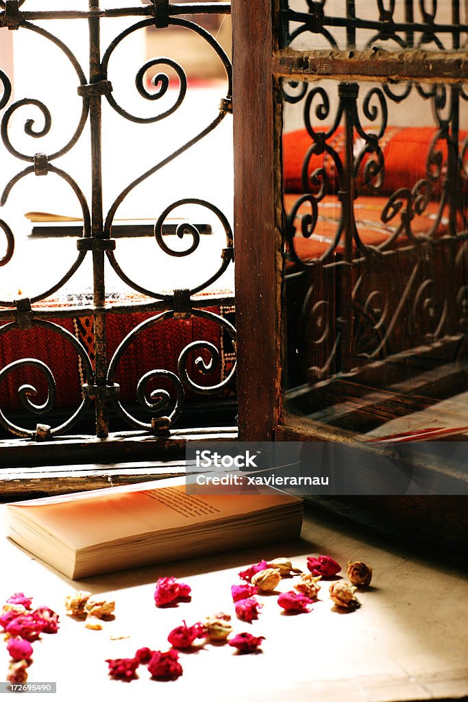 Book - XXL Book and flowers in front of a window. Advice Stock Photo