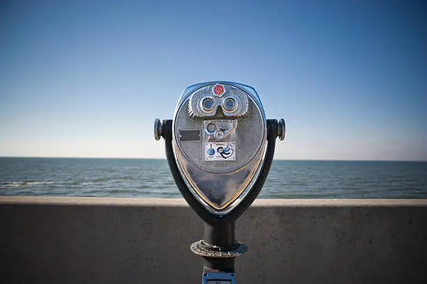 Photo of binoculars by the water