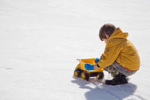 istock Kid Playing With Truck Toy On Snow 172696486
