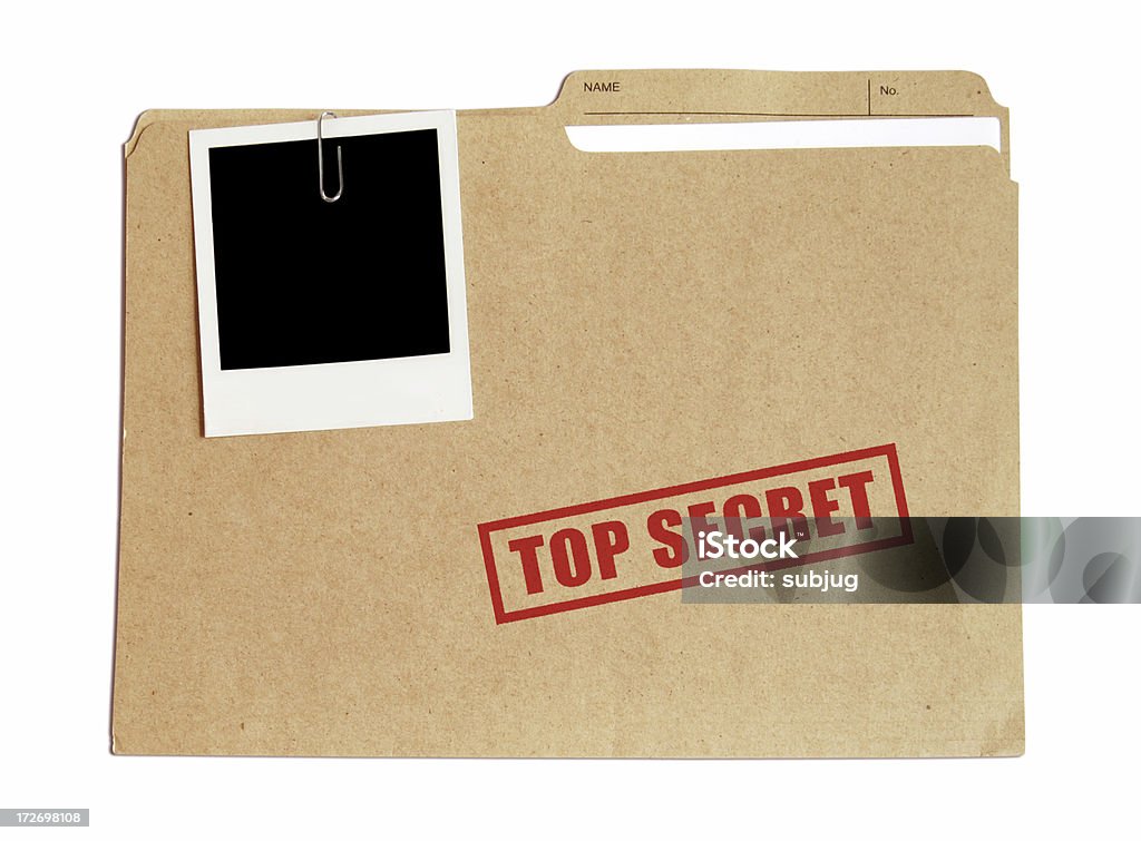 Top secret file in a folder with a Polaroid attached Top secret folder with document and picture File Folder Stock Photo