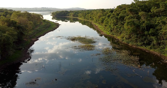 River flowing trough the Brazilian cerrado with clouds reflecting in the water