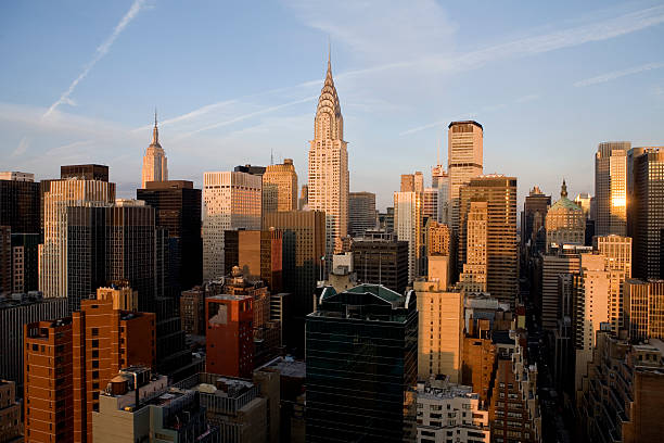 The sun rises over New York City.