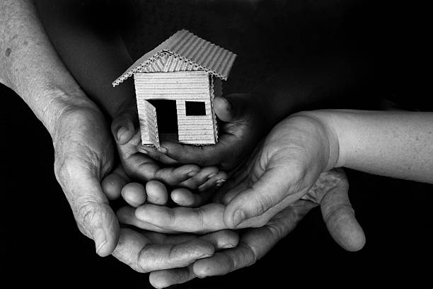 shelter three sets of hands:  older woman, middle-aged woman, small child holding a model house sheltering photos stock pictures, royalty-free photos & images