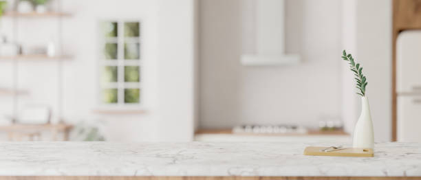 istock Mockup space on a luxury white kitchen tabletop in a modern white kitchen. 1727010846