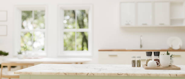 istock Copy space on a luxury white marble kitchen tabletop in a modern white kitchen. 1727011382