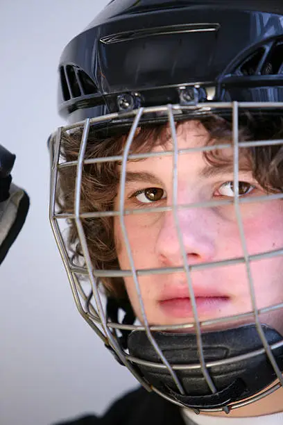 teenager with his hockey helmet on