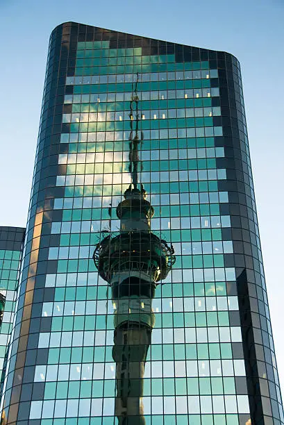 The symbol of Auckland is reflected by an office tower.
