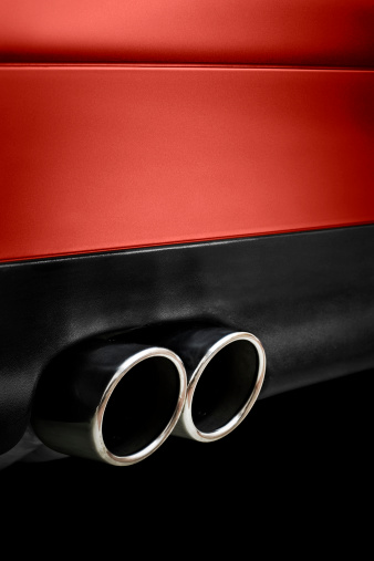 Stainless steel exhaust pipes on a red car