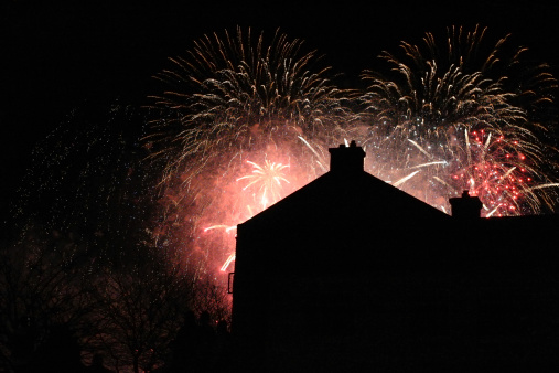 Fireworks with houses in the foreground as siluette