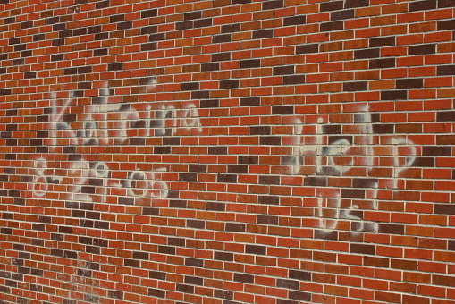 Poignant message spray painted on a wall in Bay Saint Louis, MS Mississippi, 3 weeks following Hurricane Katrina.  Many people were still sleeping on their driveways and were without assistance at this time.