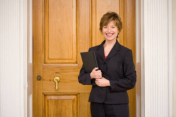 istock real estate agent at front door 172703871