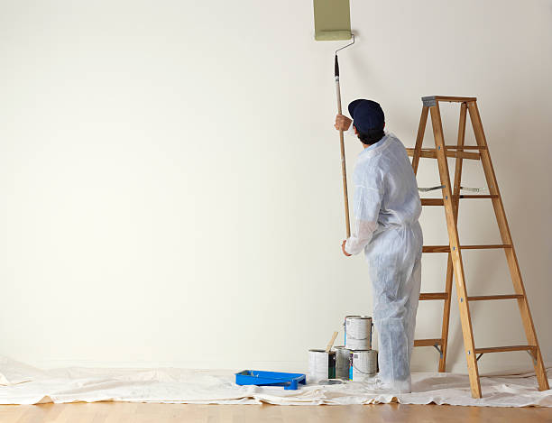 istock House painter beginning to paint a large wall 172704017
