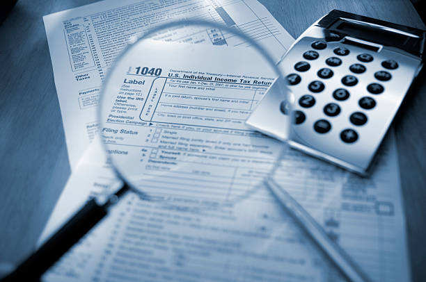 istock Magnifying Glass Examining 1040 Tax Form 172704182