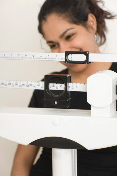 istock woman on medical weight scale 172705542