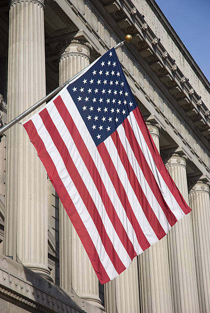 istock American Flag Hanging in front of a Classical Building 172705751