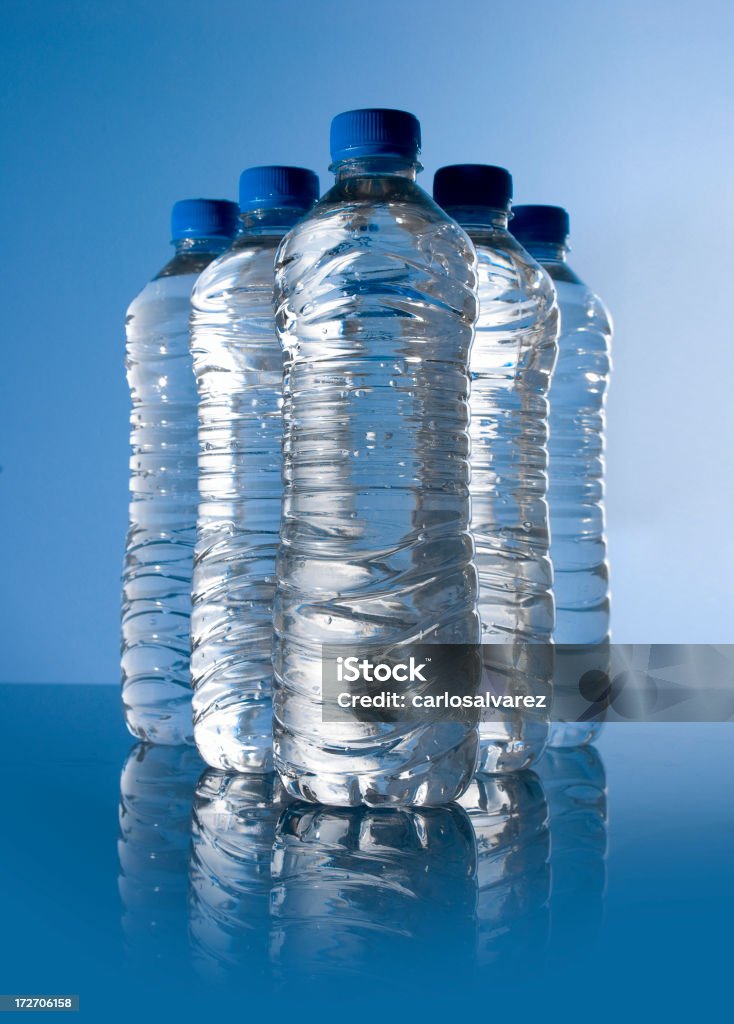 Water Bottles 5 plastic water bottles. Blue Background Blue Stock Photo