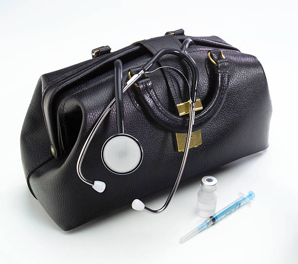 istock Physician's leather black bag with stethoscope & syringe 172708095