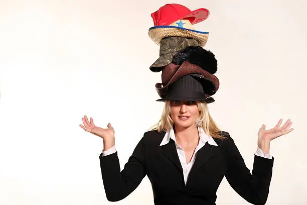 Photo of Business woman balancing life having to wear too many hats