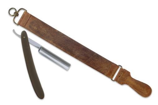 Antique Straight Edge Razor and Leather Strop Sharpener on White. Two Clipping Path Included.