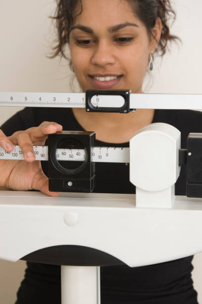 istock woman on medical weight scale 172709441