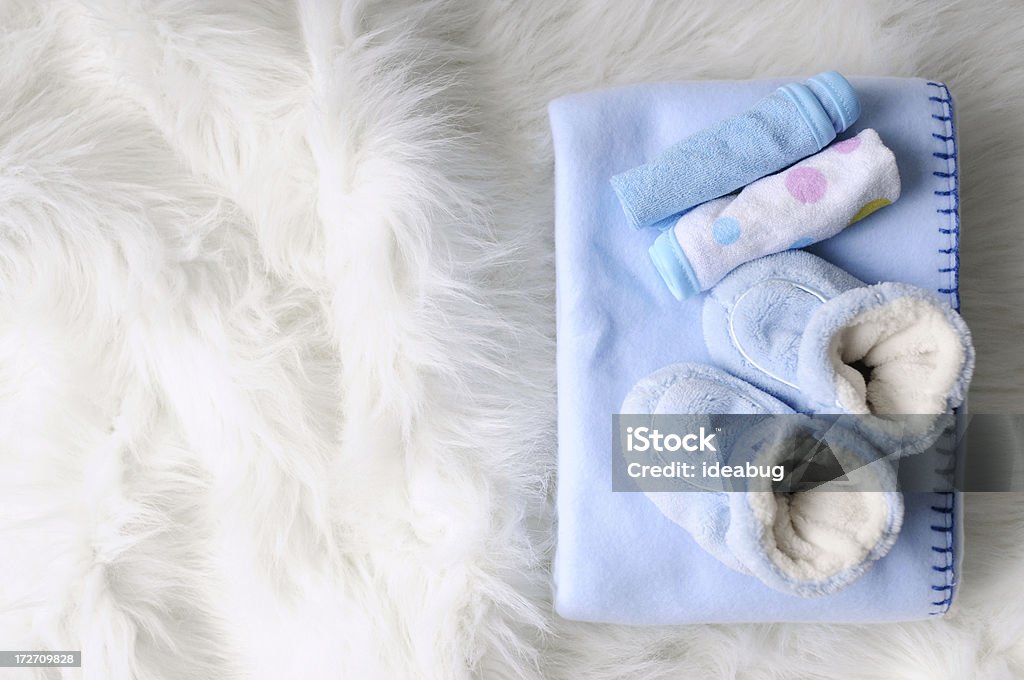 It's A Boy "Blue slippers, fleece blanket, and washcloths on a soft, fuzzy blanket ready for a new baby boy." Baby - Human Age Stock Photo